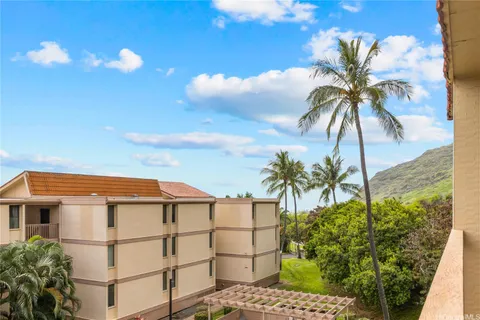 a view of a palm trees in front of a building