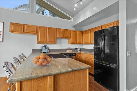 a kitchen with a sink a refrigerator and cabinets