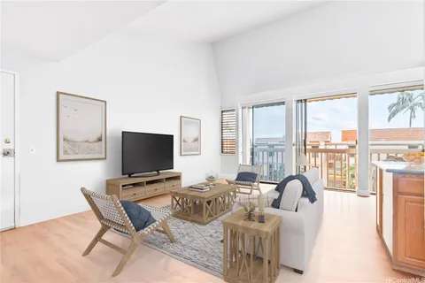 a living room with furniture a large window and a flat screen tv