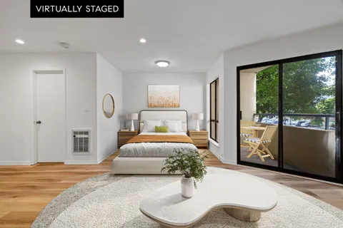 a bedroom with a large bed and a large window