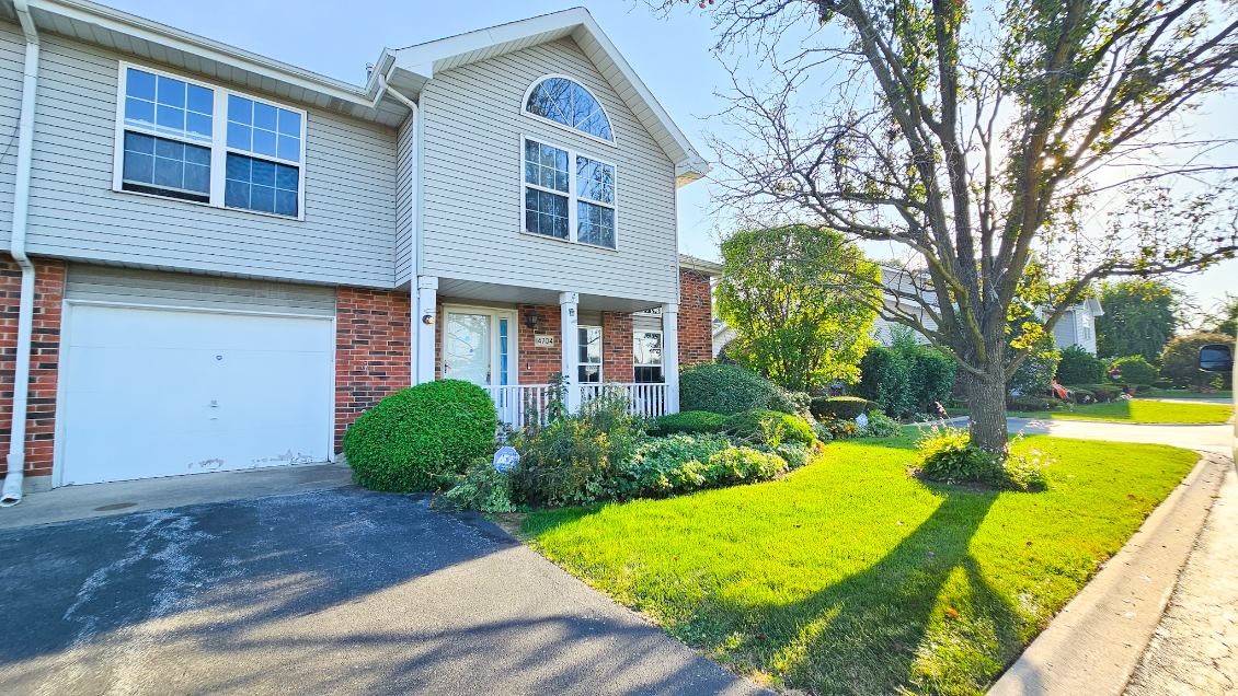 a view of a house with pool and a yard