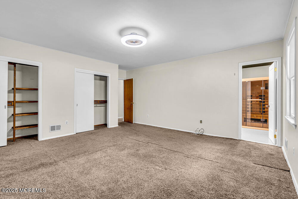 10 Bowman Road Jackson, NJ 08527 - Photo 7 of 16 an empty room with a closet and cabinet