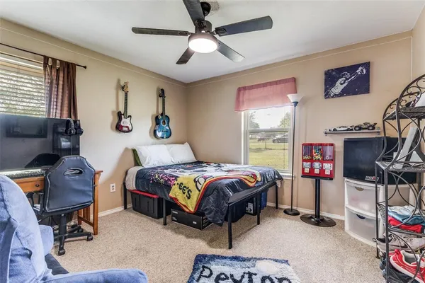 a bedroom with a bed a desk and a window