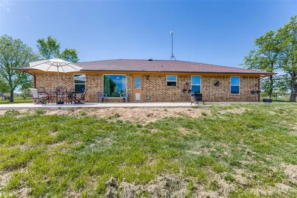 a front view of house with yard and outdoor seating