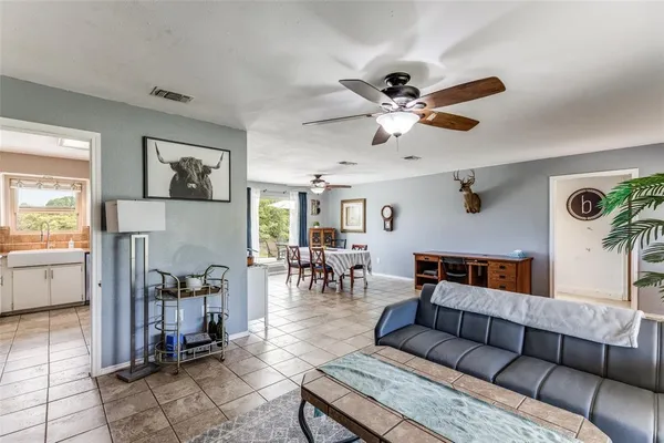 a living room with furniture and a dining table