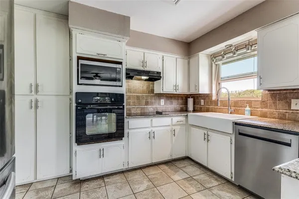 a kitchen with appliances cabinets and a sink