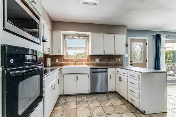 a kitchen with a sink stove and microwave