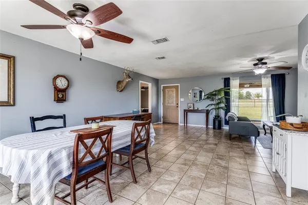 a view of a livingroom with furniture and a chandelier fan