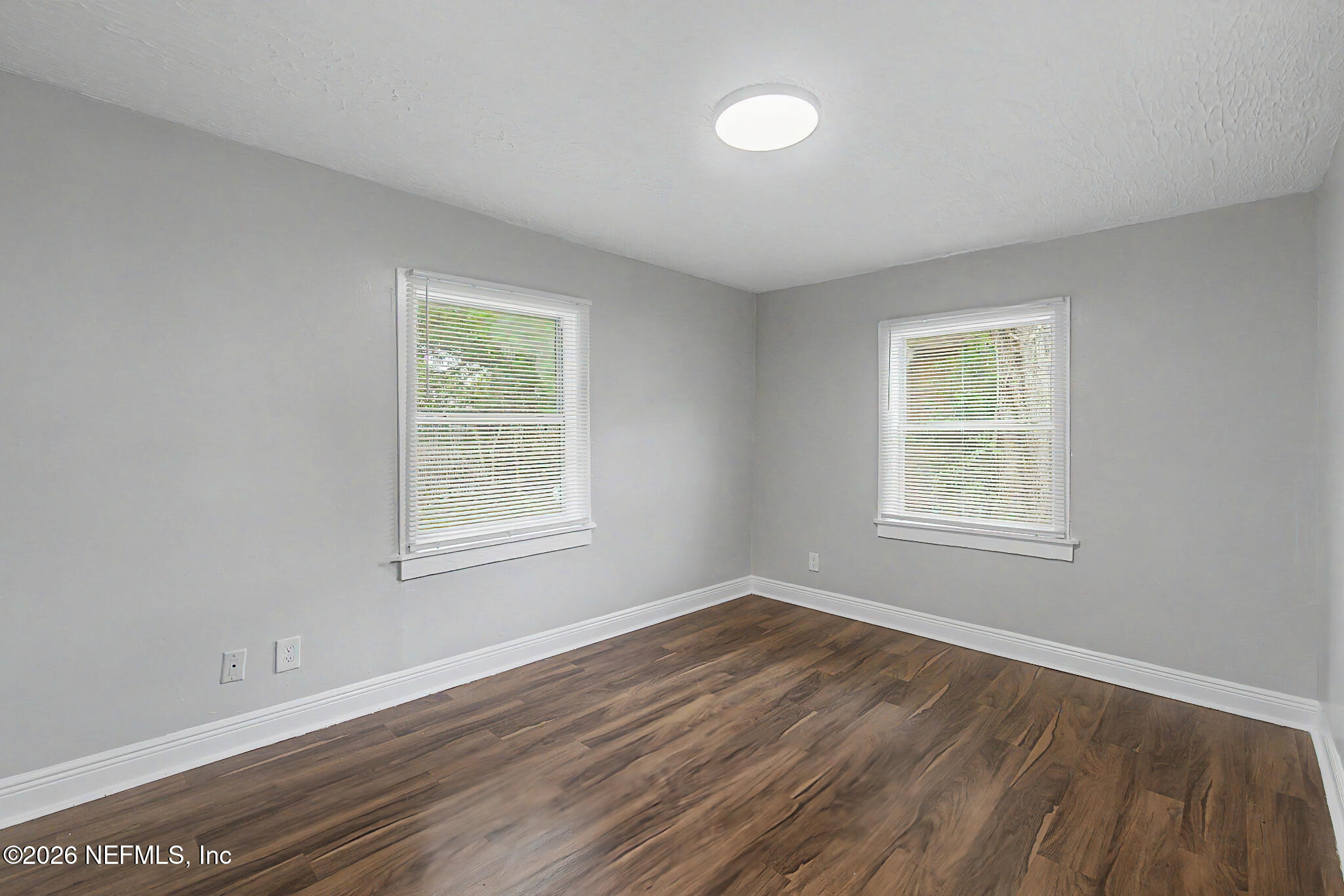 2625 Kohn Road Jacksonville, FL 32210 - Photo 20 of 34 a view of an empty room with wooden floor and a window