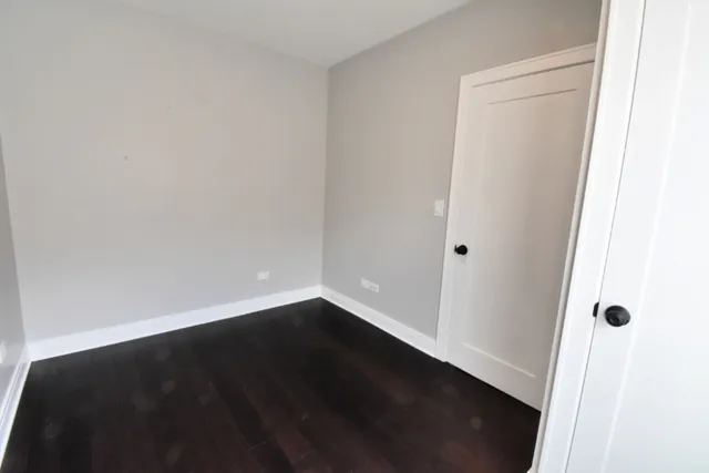 an empty room with wooden floor