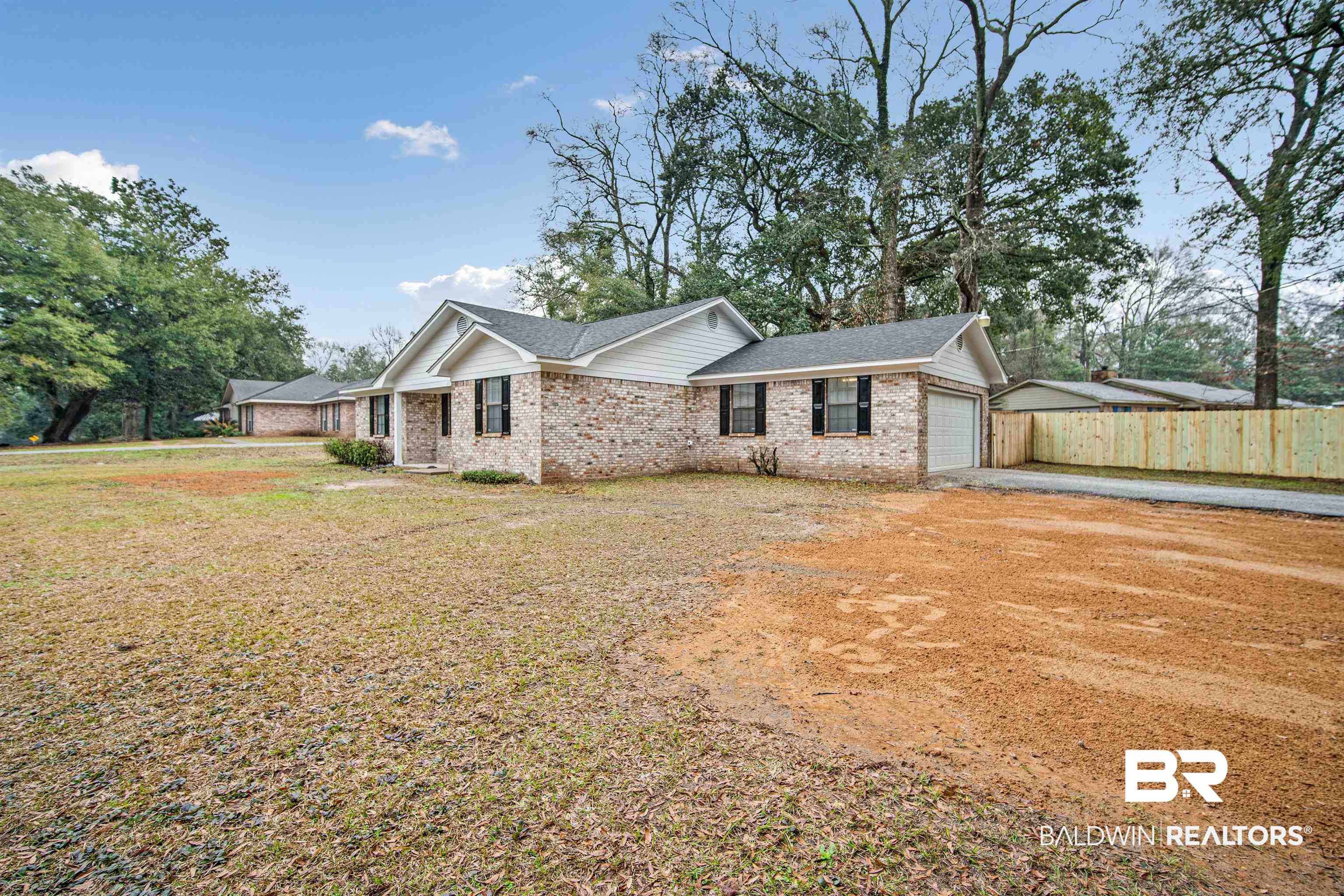 6701 Howells Ferry Road Mobile, AL 36618 - Photo 3 of 25 View of front of house with a garage and a front yard