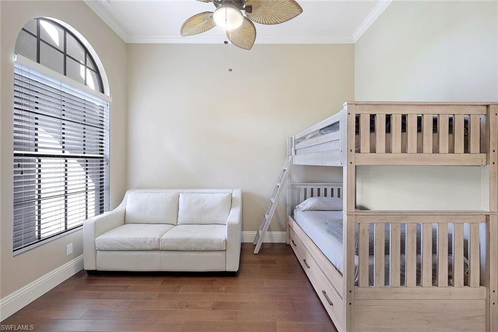 7598 Moorgate Point Way Naples, FL 34113 - Photo 16 of 33 a bedroom with furniture and a window
