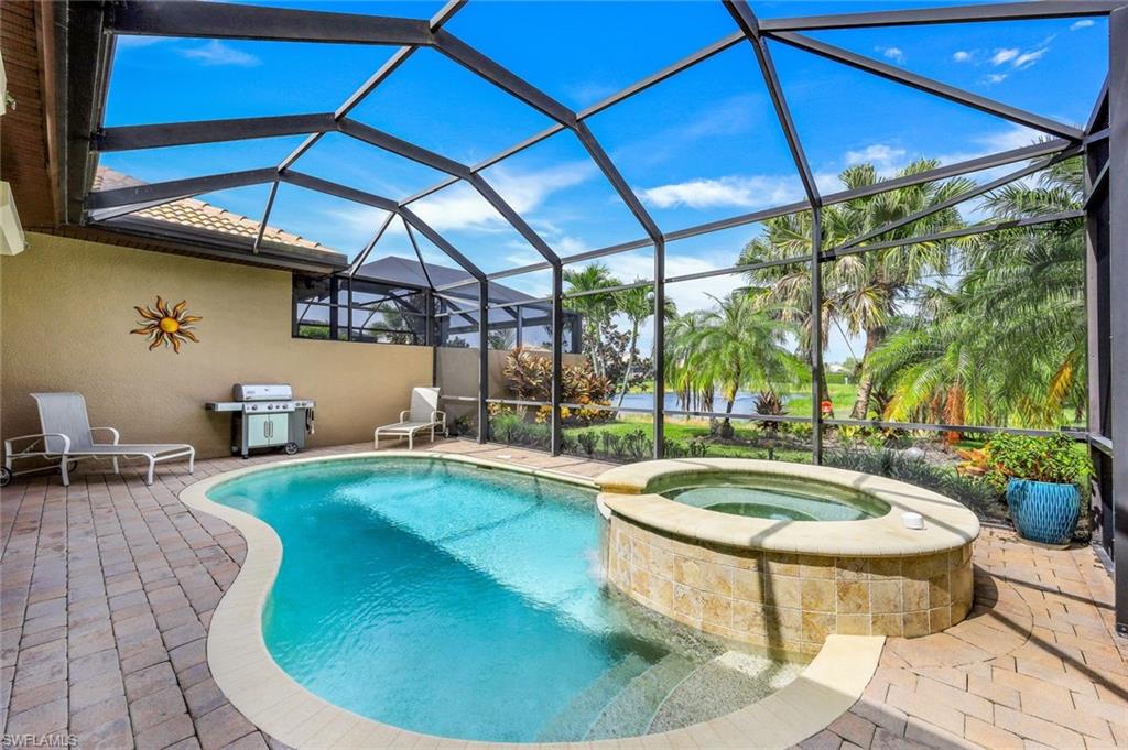 7598 Moorgate Point Way Naples, FL 34113 - Photo 24 of 33 a view of a swimming pool with a patio