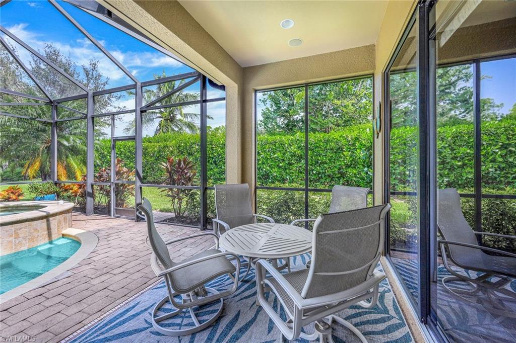 7598 Moorgate Point Way Naples, FL 34113 - Photo 26 of 33 a view of a porch with furniture and wooden floor