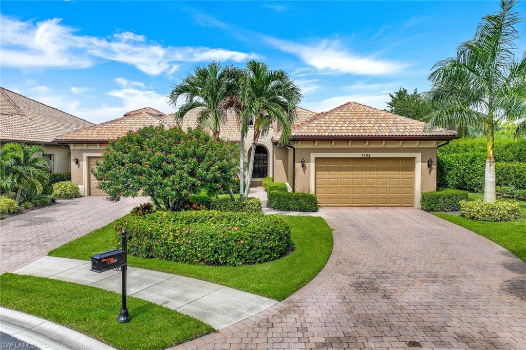 7598 Moorgate Point Way Naples, FL 34113 - Photo 27 of 33 a front view of a house with garden
