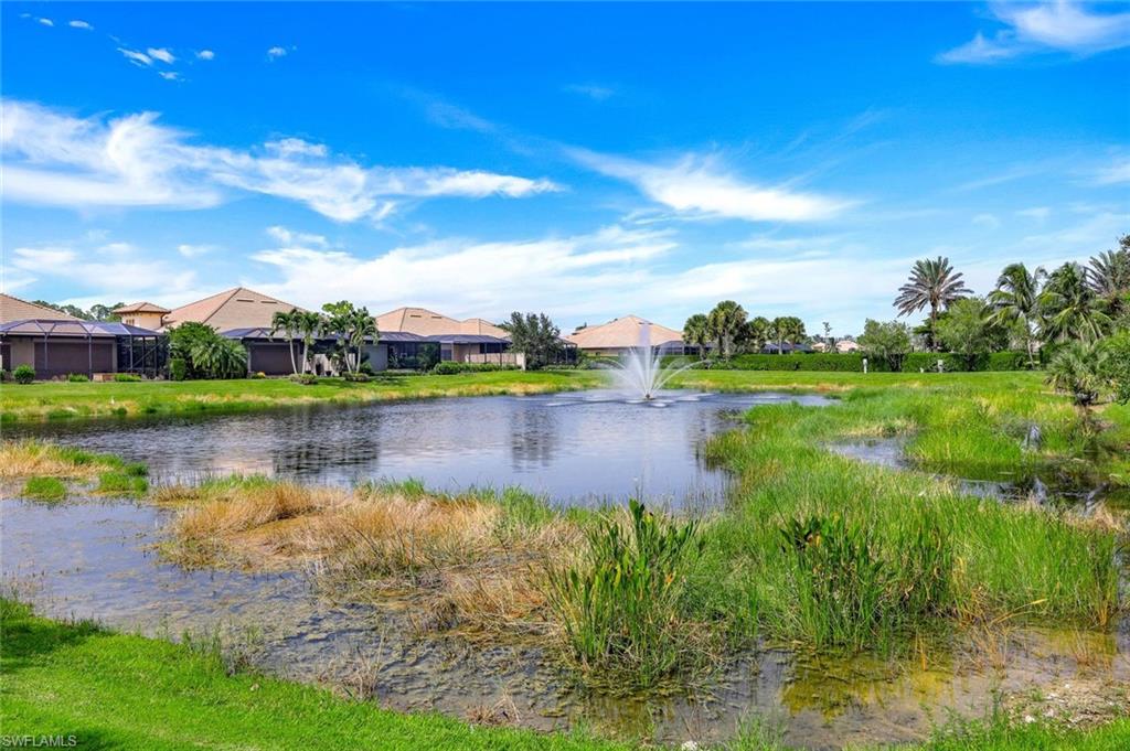 7598 Moorgate Point Way Naples, FL 34113 - Photo 30 of 33 a view of a lake with houses in the back