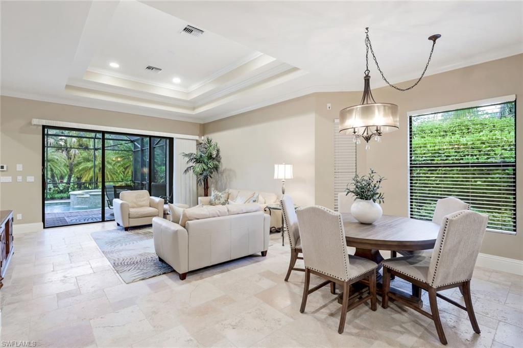 7598 Moorgate Point Way Naples, FL 34113 - Photo 5 of 33 a living room with furniture and a floor to ceiling window