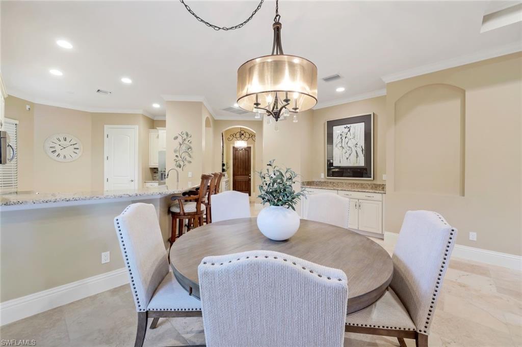 7598 Moorgate Point Way Naples, FL 34113 - Photo 6 of 33 a view of a dining room with furniture and chandelier
