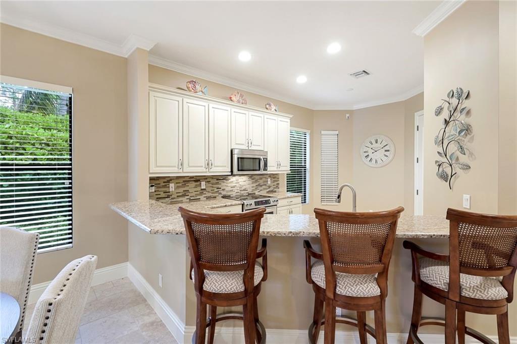 7598 Moorgate Point Way Naples, FL 34113 - Photo 10 of 33 a view of a dining room with furniture window and outside view