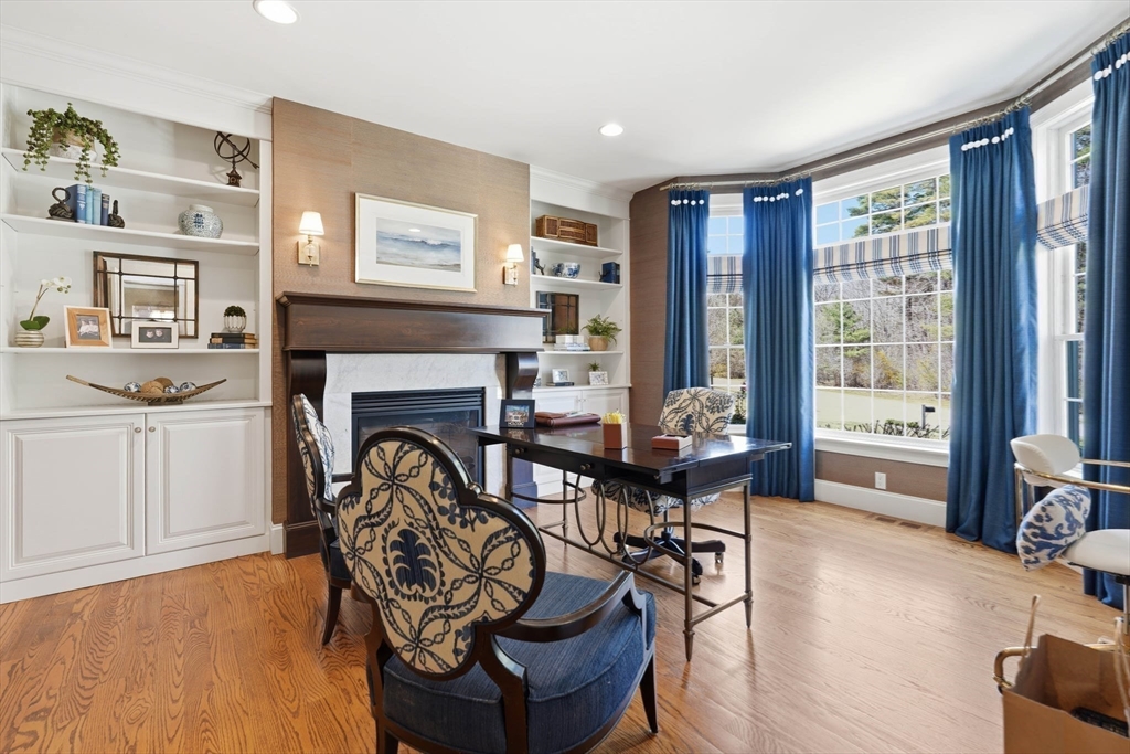 9 Ross Lane Middleton, MA 01949 - Photo 11 of 42 a living room with furniture a fireplace and a large window