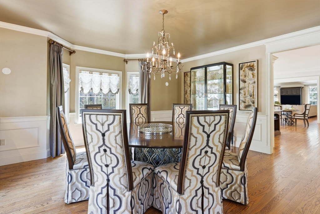 9 Ross Lane Middleton, MA 01949 - Photo 14 of 42 a view of a dining room with furniture wooden floor and chandelier
