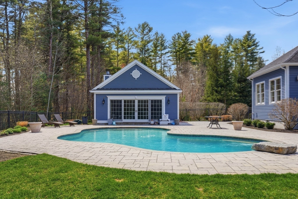 9 Ross Lane Middleton, MA 01949 - Photo 32 of 42 a front view of a house with garden and patio