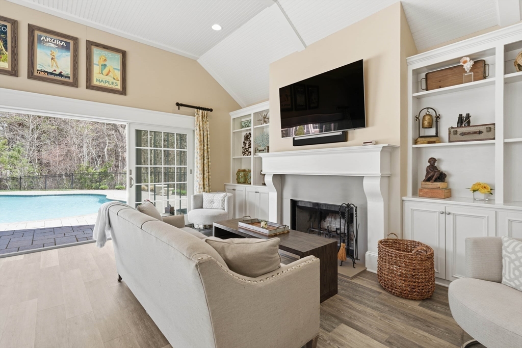 9 Ross Lane Middleton, MA 01949 - Photo 35 of 42 a living room with furniture a flat screen tv and a fireplace