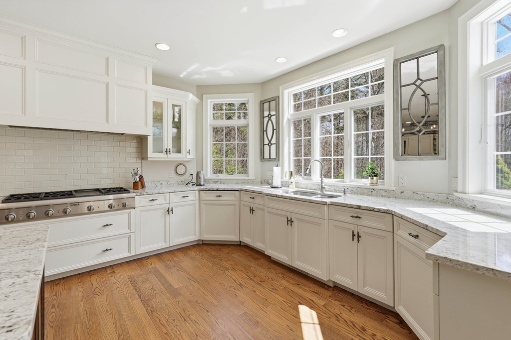 9 Ross Lane Middleton, MA 01949 - Photo 6 of 42 a kitchen with granite countertop cabinets stainless steel appliances a sink and a window