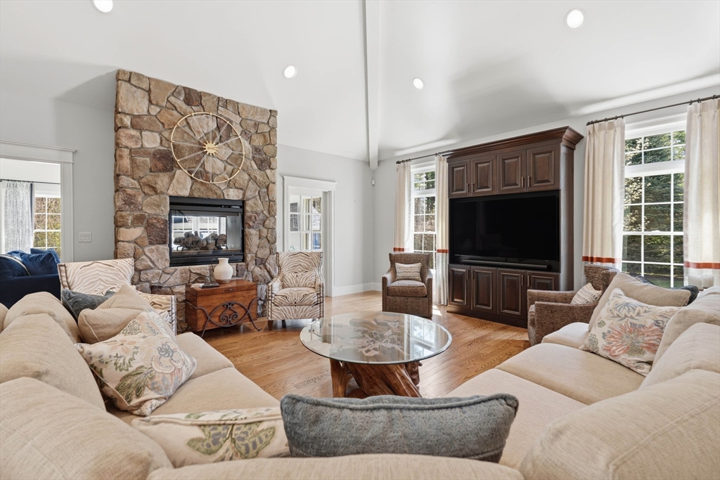 9 Ross Lane Middleton, MA 01949 - Photo 9 of 42 a living room with furniture and a flat screen tv