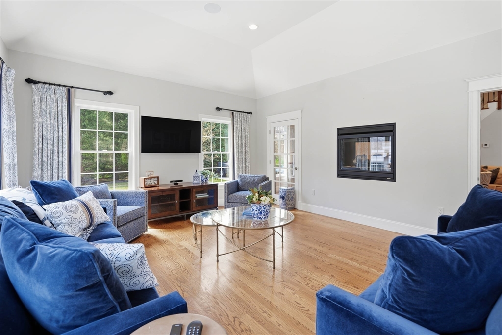 9 Ross Lane Middleton, MA 01949 - Photo 10 of 42 a living room with furniture flat screen tv and a large window