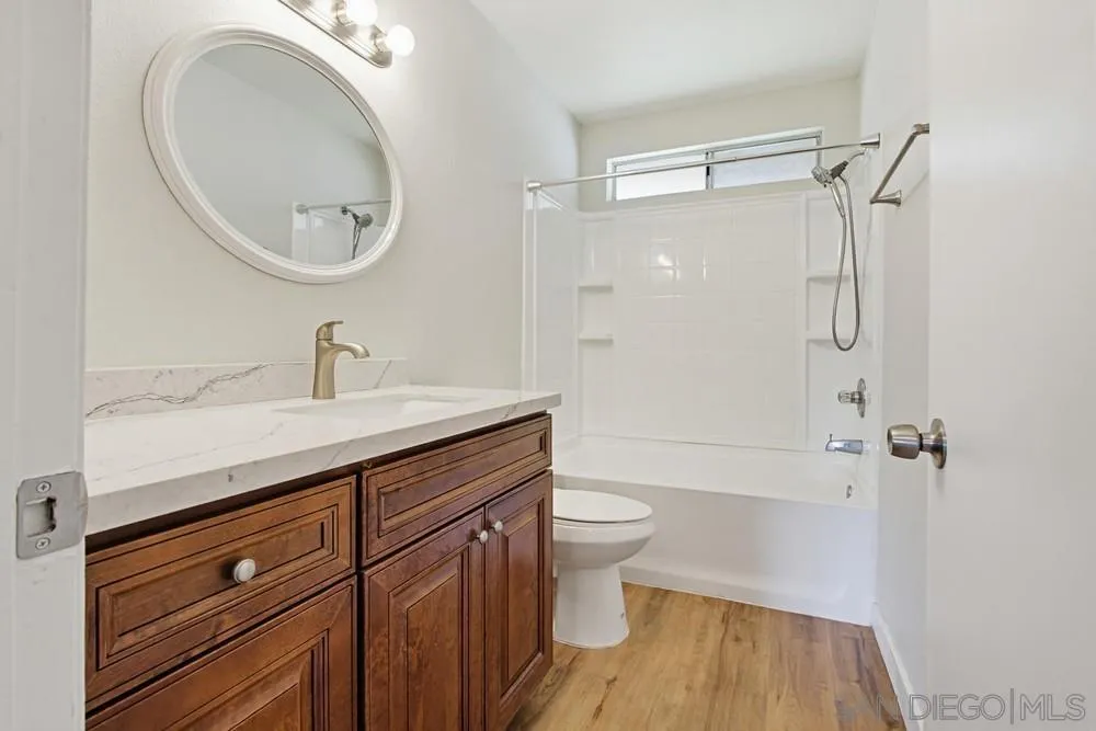 5130 North River Road, Unit B Oceanside, CA 92057 - Photo 30 of 51 a bathroom with a sink a toilet and shower