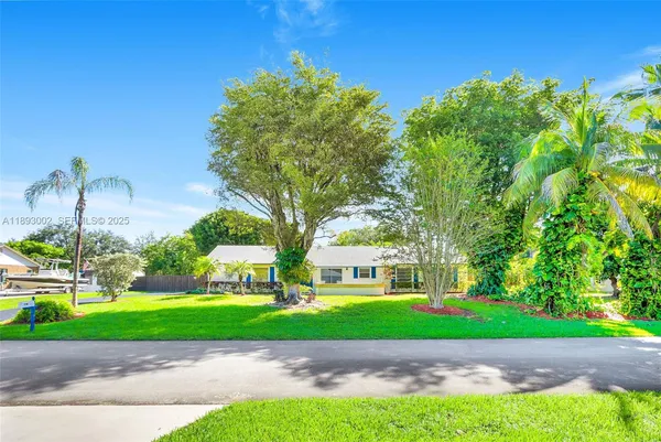 a view of a park with a house in the background
