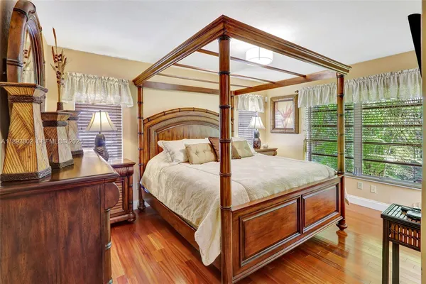 a bed sitting in a bedroom next to a window