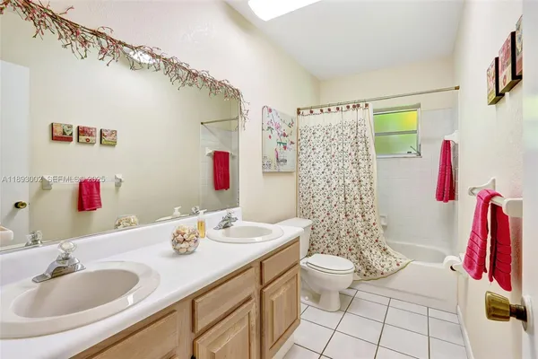 a bathroom with a sink vanity mirror and toilet