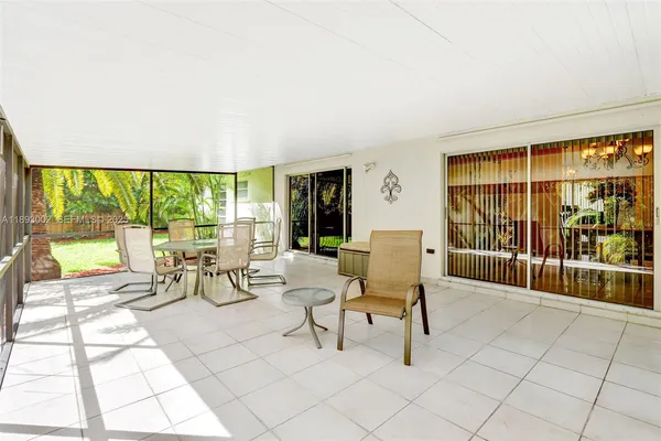 a building outdoor space with patio furniture and potted plants