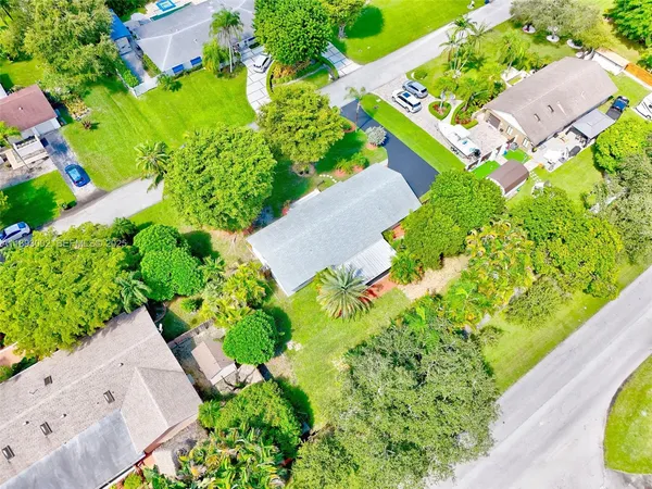 an aerial view of residential houses with yard
