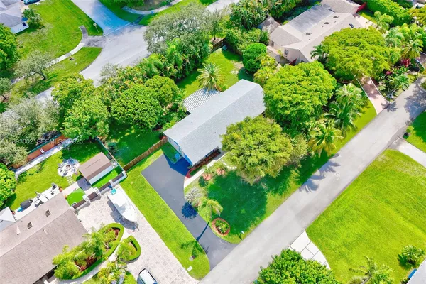an aerial view of a house with a yard and outdoor seating