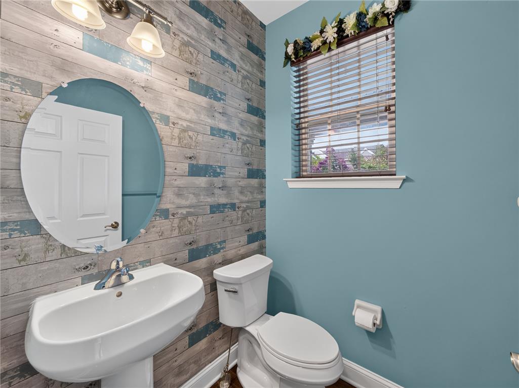 2765 Farmstead Road Easton, PA 18040 - Photo 9 of 50 A quaint powder room features a pedestal sink and distressed wood-panel accent wall.