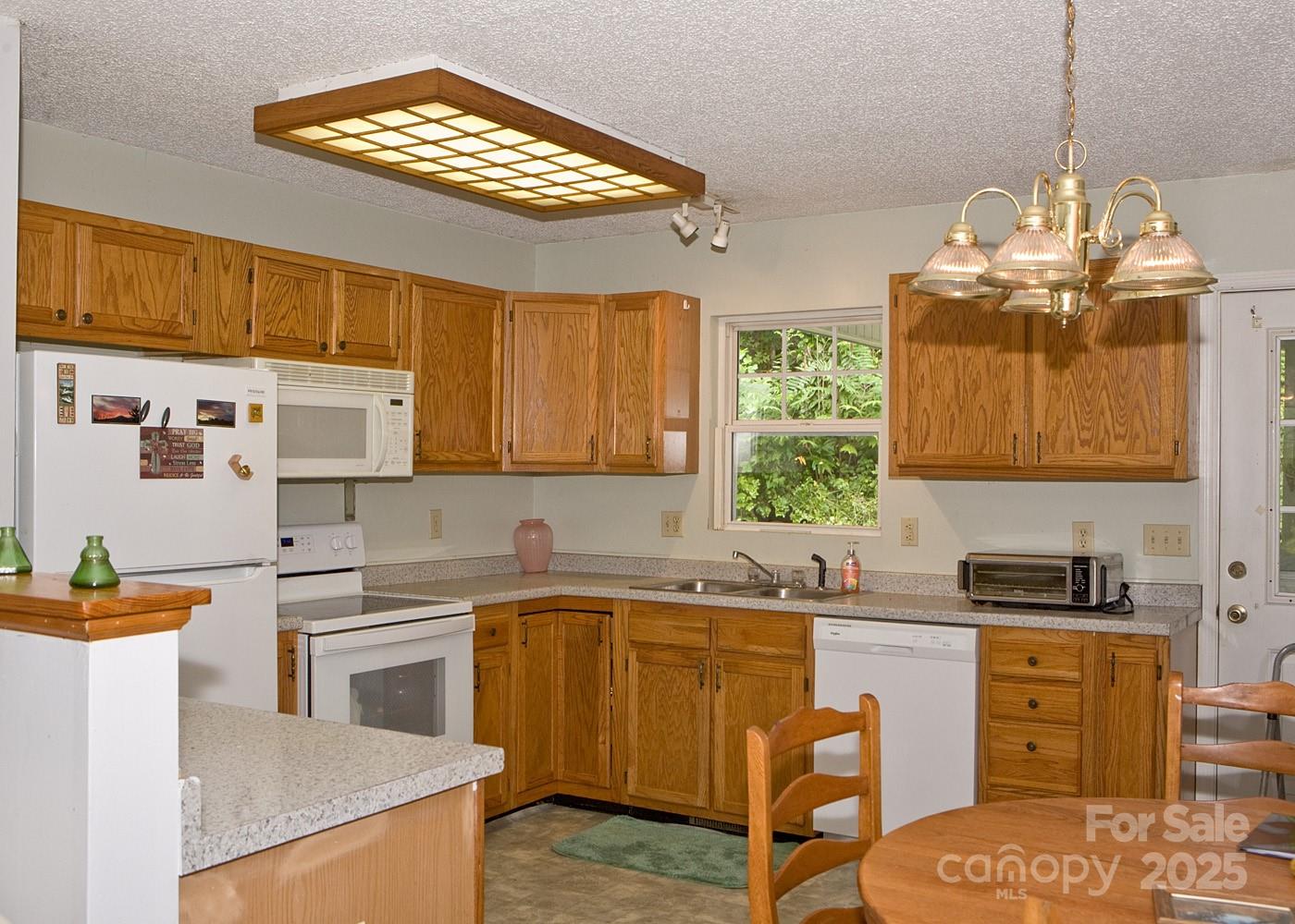 165 Peepeye Cove Road Leicester, NC 28748 - Photo 12 of 24 a kitchen with a sink stove and cabinets