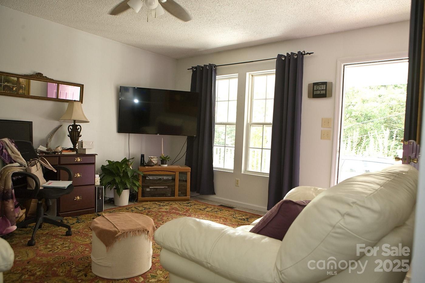 165 Peepeye Cove Road Leicester, NC 28748 - Photo 17 of 24 a bedroom with a bed and a flat screen tv