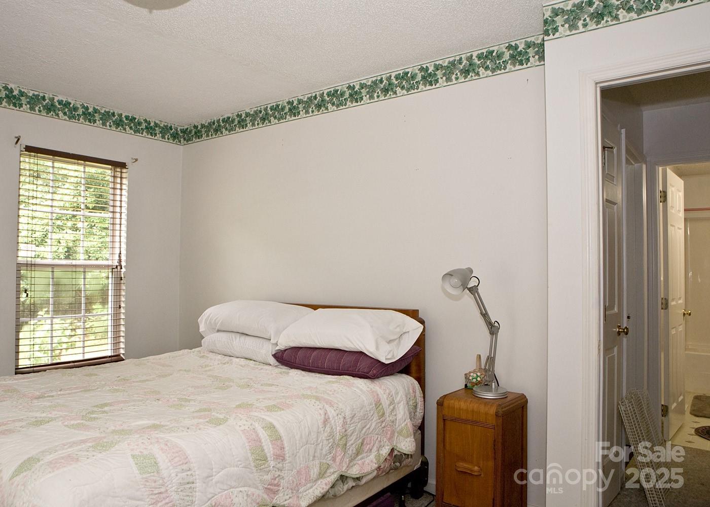 165 Peepeye Cove Road Leicester, NC 28748 - Photo 7 of 24 a bedroom with a bed and a window