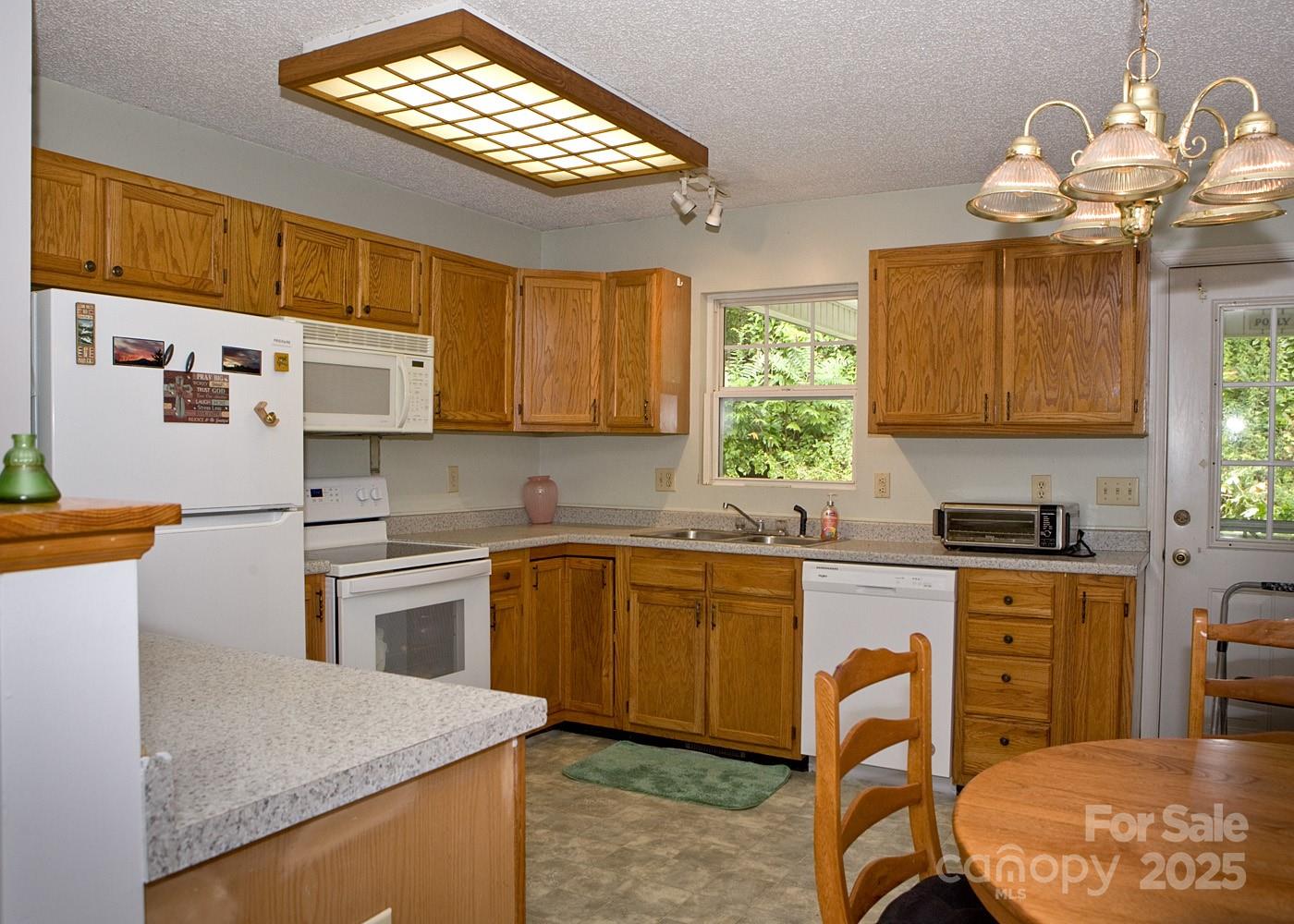165 Peepeye Cove Road Leicester, NC 28748 - Photo 9 of 24 a kitchen with stainless steel appliances granite countertop a sink a stove cabinets counter space and a window