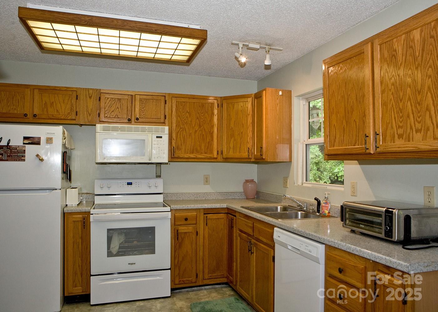 165 Peepeye Cove Road Leicester, NC 28748 - Photo 10 of 24 a kitchen with stainless steel appliances a stove sink and cabinets