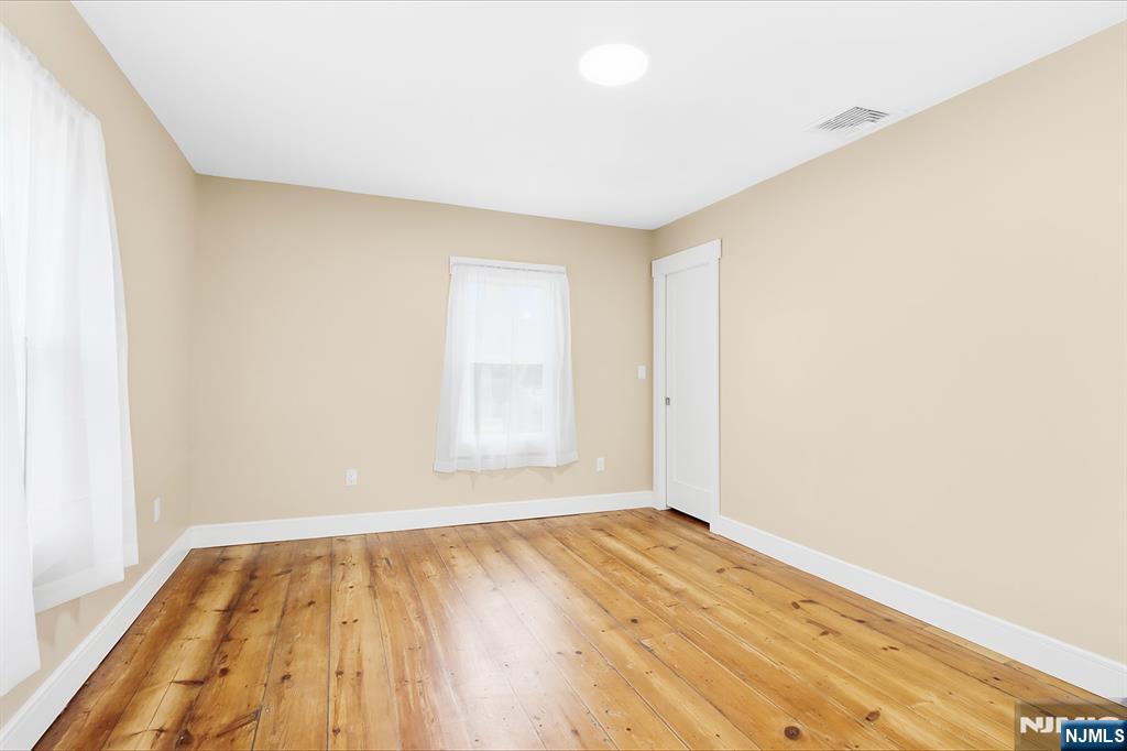 36 Pascack Road, Unit 2 Park Ridge, NJ 07656 - Photo 12 of 22 an empty room with wooden floor and windows