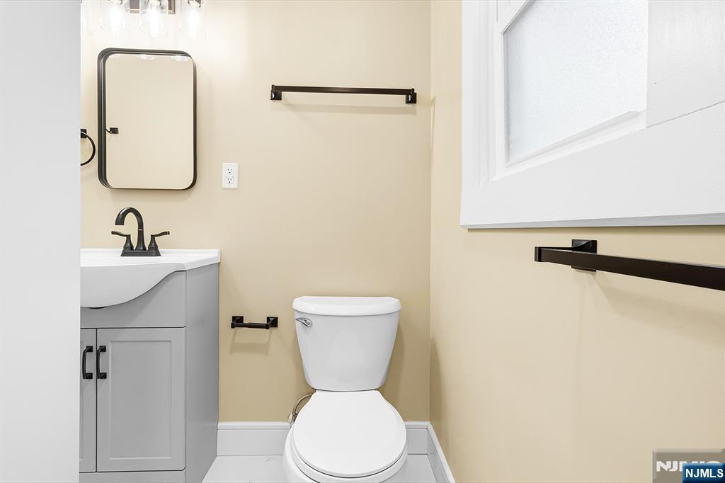 36 Pascack Road, Unit 2 Park Ridge, NJ 07656 - Photo 14 of 22 a bathroom with a toilet sink and mirror