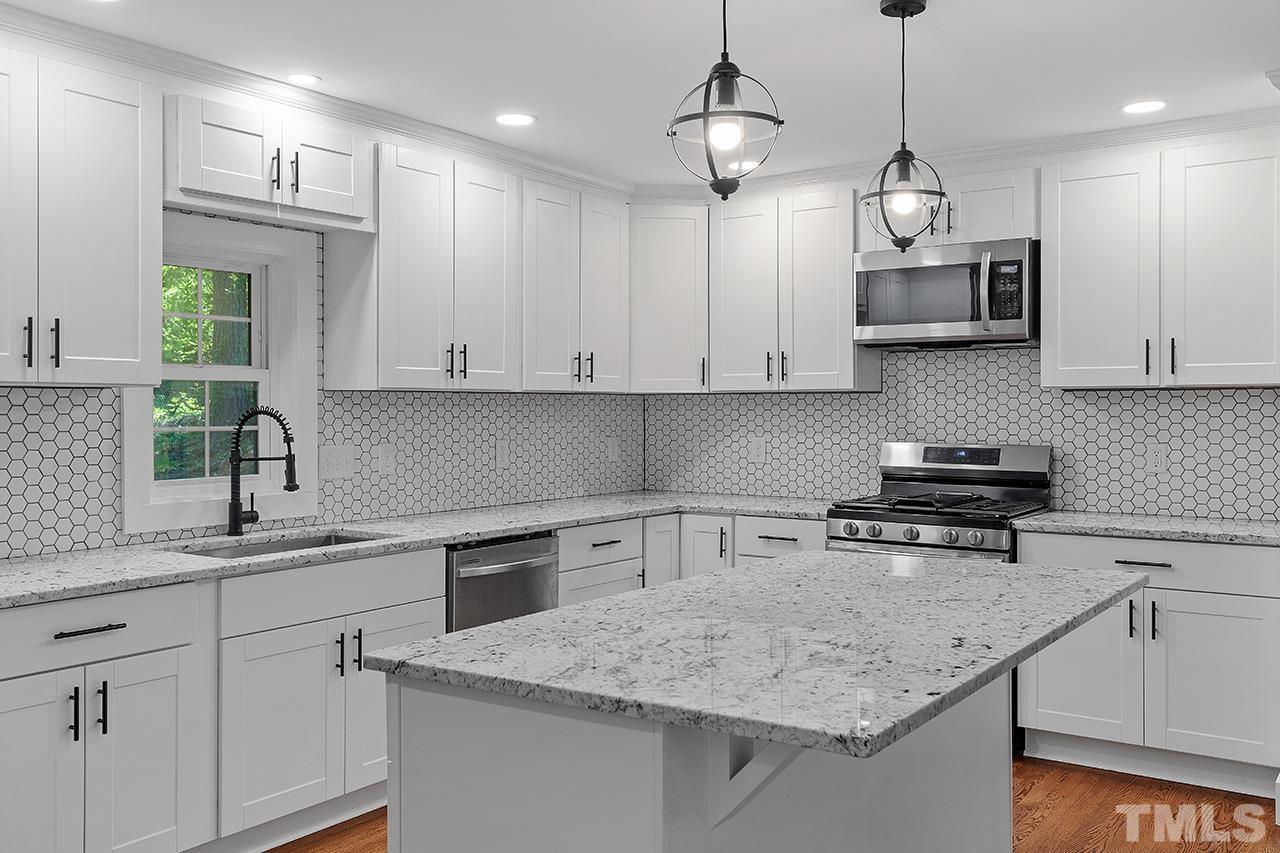 2609 Elmhurst Circle Raleigh, NC 27610 - Photo 11 of 34 a kitchen with stainless steel appliances granite countertop a sink a stove and a granite counter tops