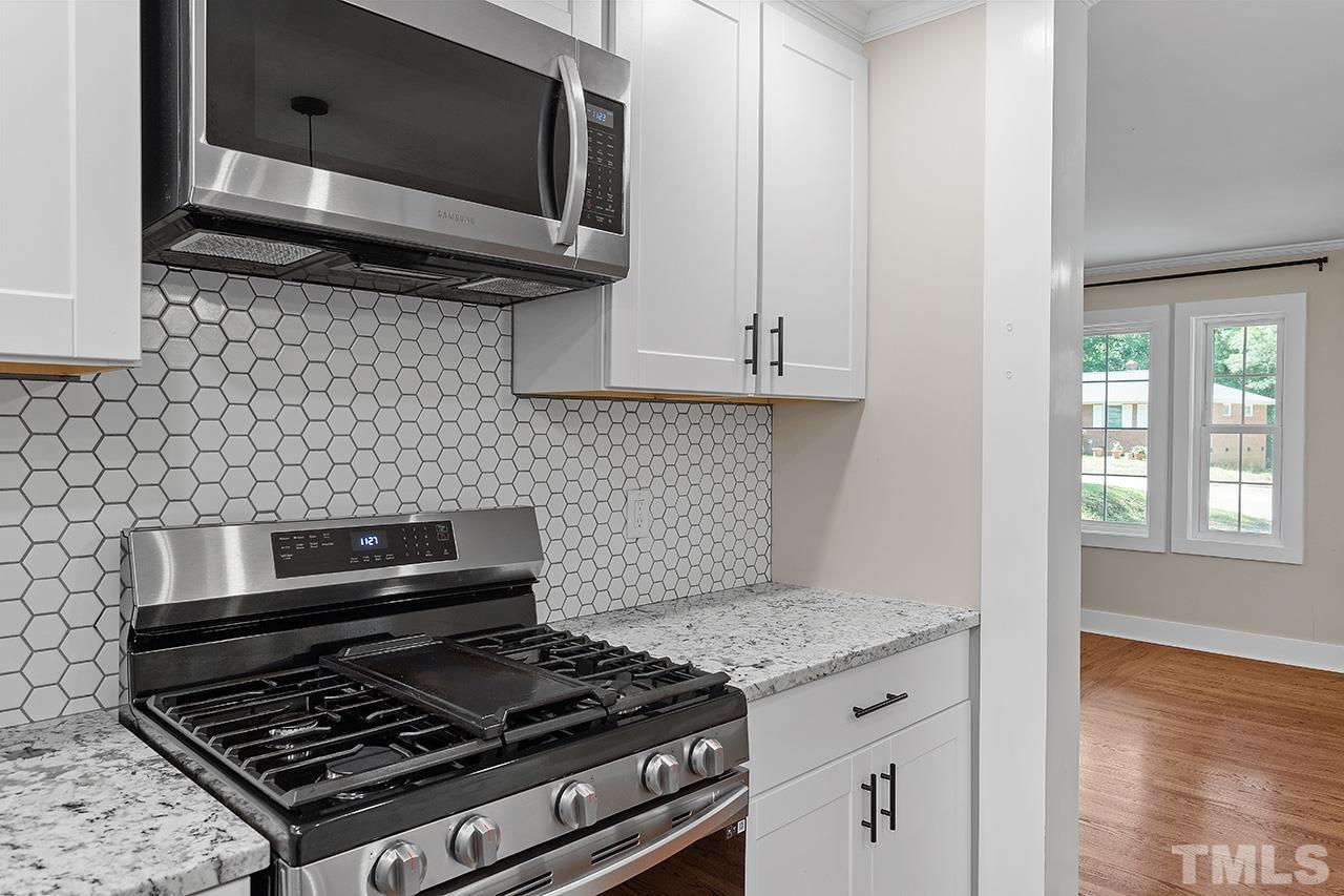 2609 Elmhurst Circle Raleigh, NC 27610 - Photo 13 of 34 a kitchen with a stove and a microwave