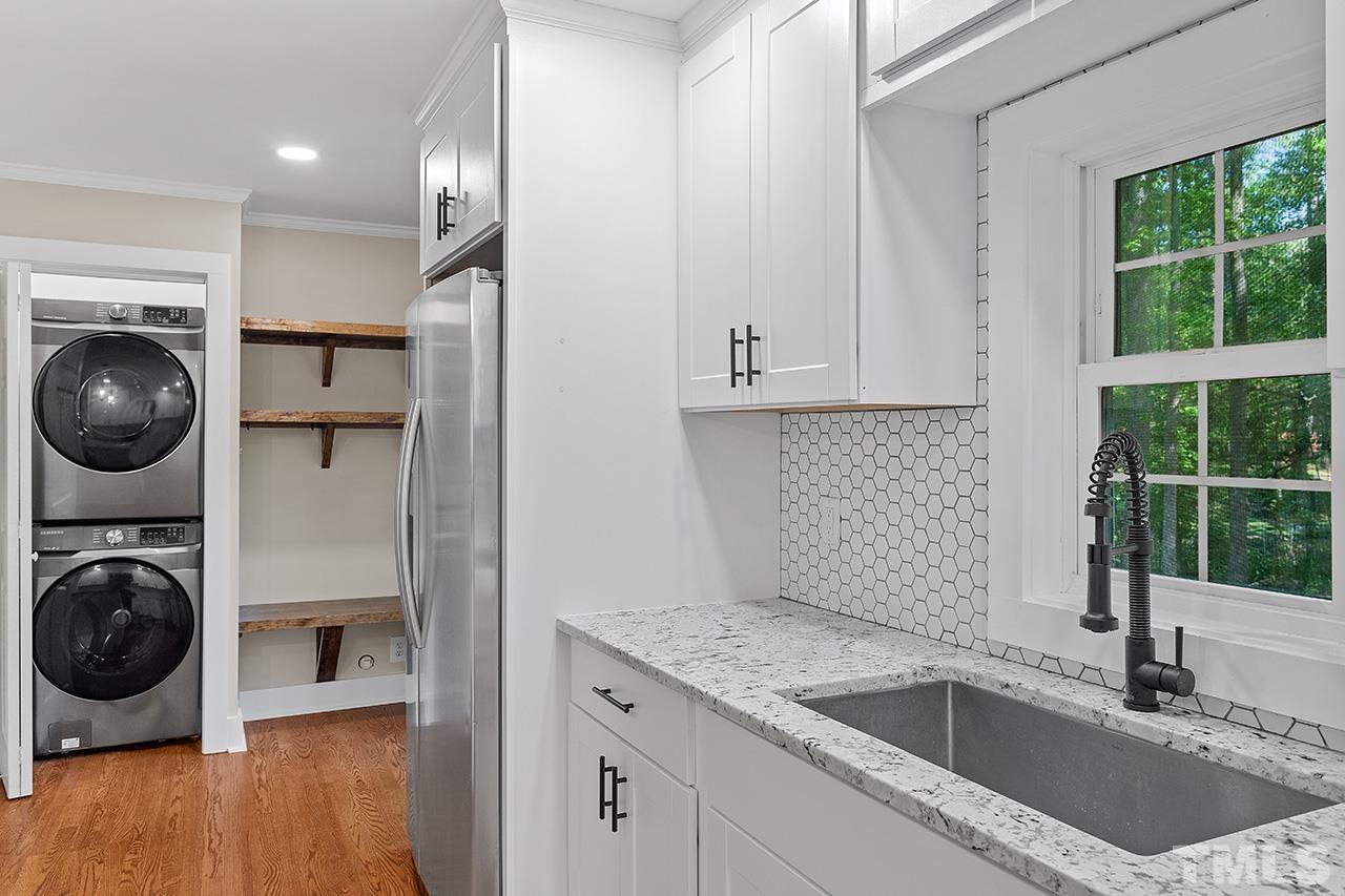 2609 Elmhurst Circle Raleigh, NC 27610 - Photo 14 of 34 a kitchen with a sink and a stove top oven