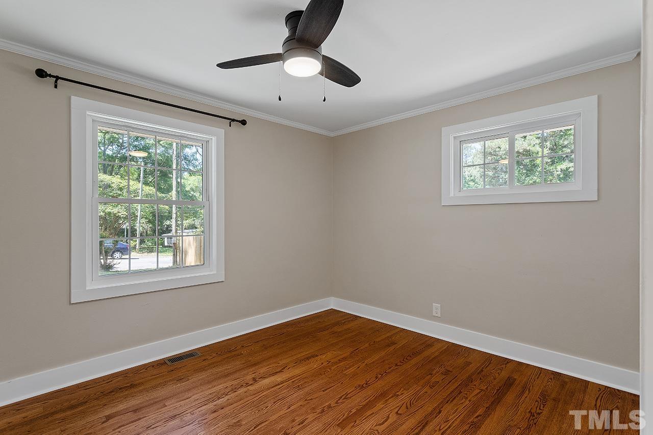 2609 Elmhurst Circle Raleigh, NC 27610 - Photo 20 of 34 a view of an empty room with wooden floor and a window