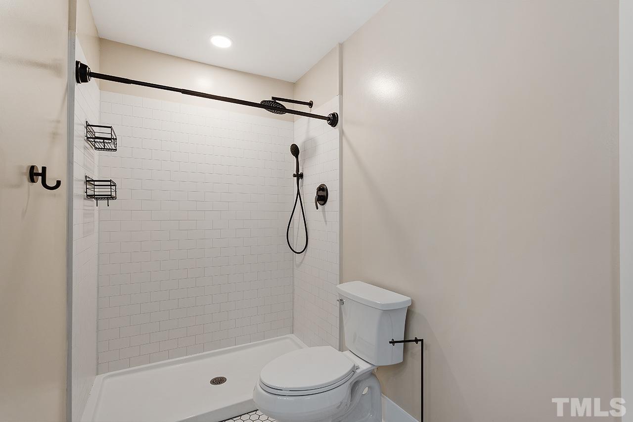 2609 Elmhurst Circle Raleigh, NC 27610 - Photo 22 of 34 a bathroom with a shower and a toilet